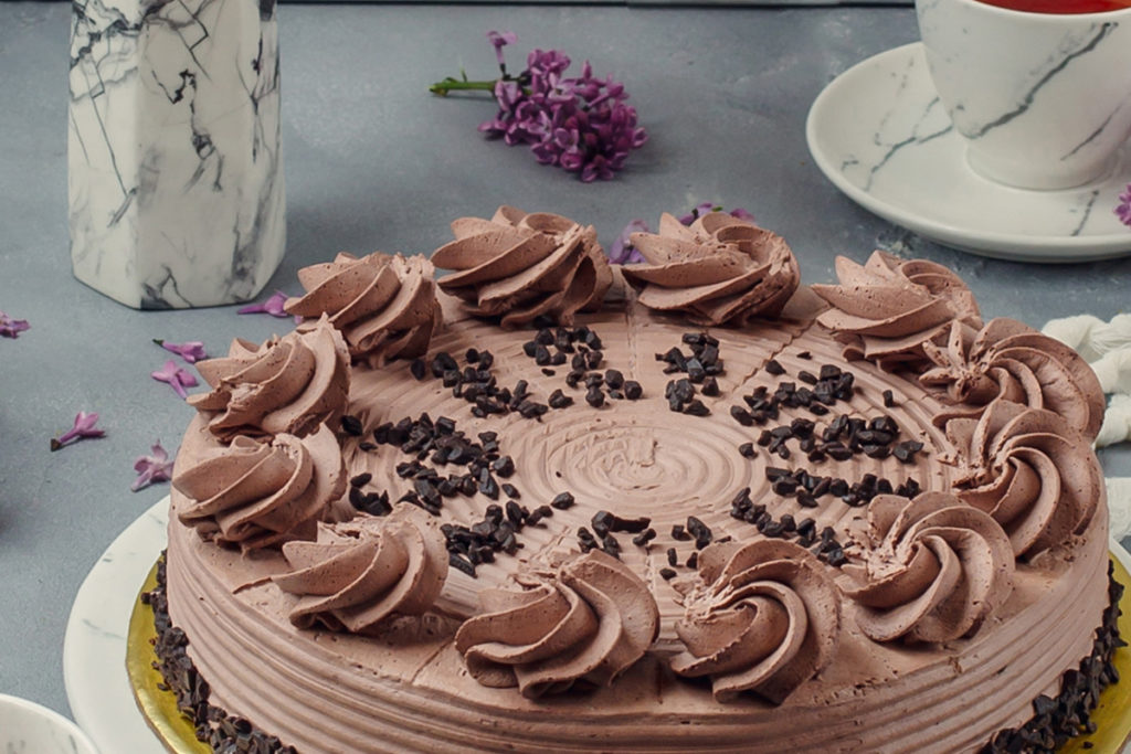 Chocolate whipped cream frosting on cake