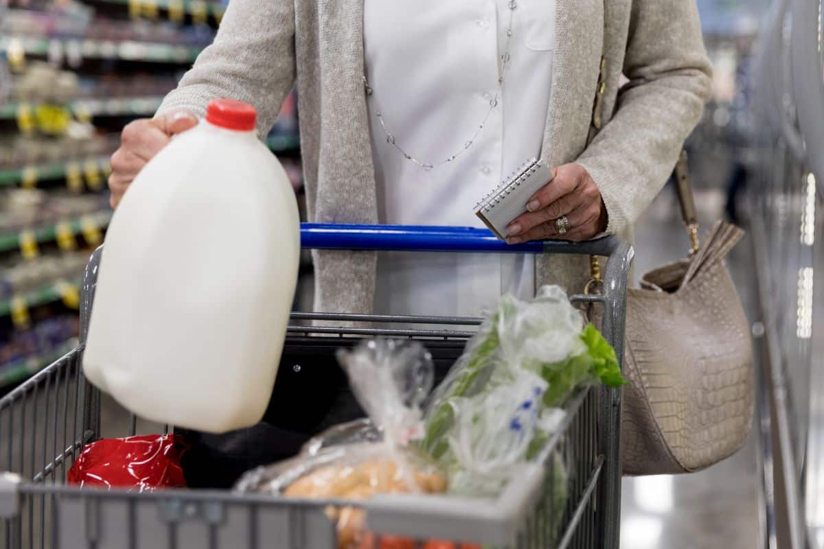 woman holding a gallon of milk - how much does a gallon of milk weigh
